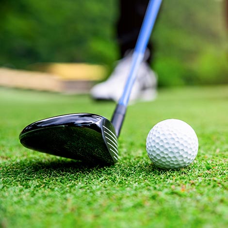 Close up golf ball on green grass field. sport golf club