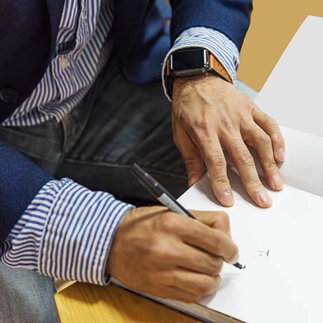 a male writer signing a book author signing book inside cover