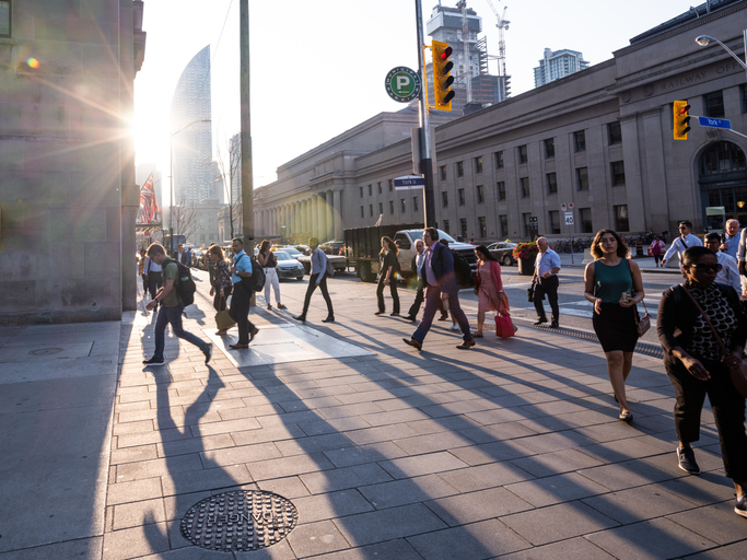 Toronto City Skyline - Morning Rush Hour Toronto, Ontario, Canada - July 29, 2019: The Toronto city skyline during the early morning hours. It is rush hour and people/commuters are coming into the city, via mass transit, in order to go to work. Union Station is represented in this photo. It is the main transportation hub in downtown Toronto. It is the main hub for Via Rail, a cross Canada rail service and it is also a main hub for other light rail and subway systems. This is Front Street facing East.