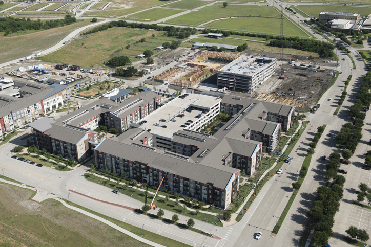 Multi-family project being completed, aerial perspective showing construction activity and finished sections.