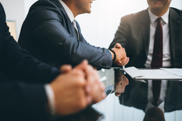 Business people shaking hands, finishing up a deal