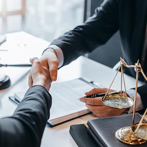 Lawyer who provides legal advice in the office. Businessman and lawyer shaking hands. Barry Frankel handshake