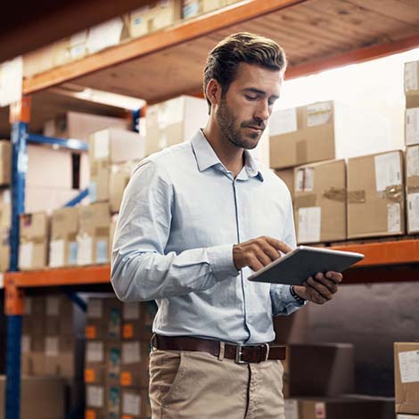 man reviewing iPad in warehouse