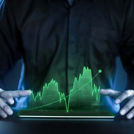 Business man showing profitable stock market holographic technology graphs in modern work background for the future. Company managers in concept planning and managing global marketing and investment.