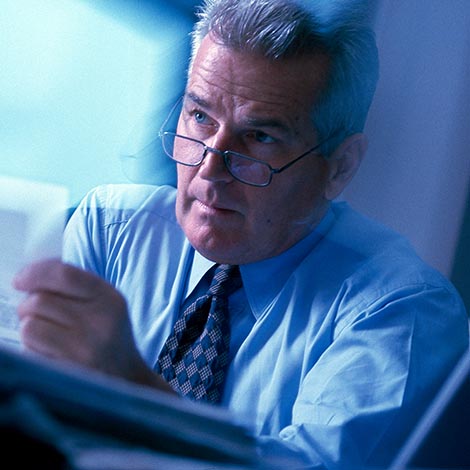 Busy mature (50s) executive in action in office setting. Busy mature (50s) executive in action in office setting.