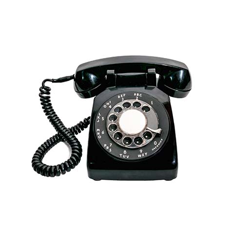 Close up shot of a black vintage rotary dial telephone isolated on a white background