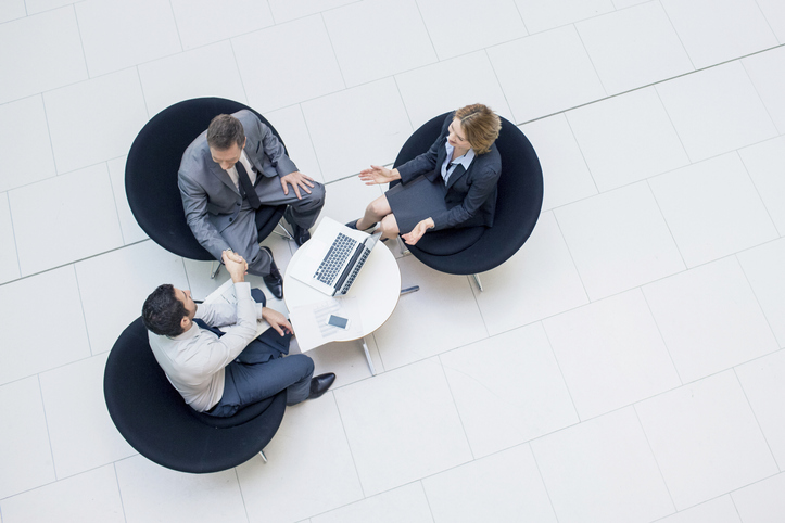 Three business people sealing a business deal.