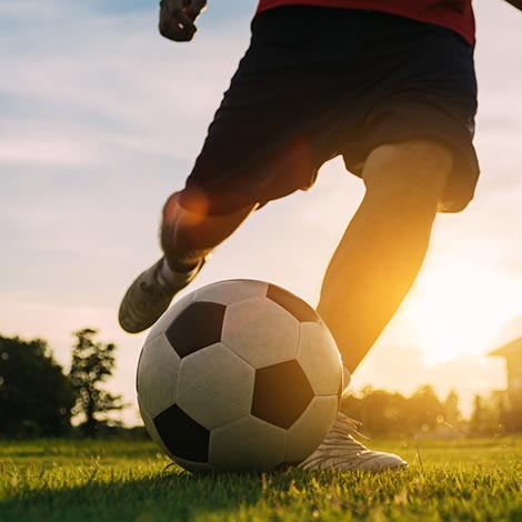 Silhouette action sport soccer player kicking ball