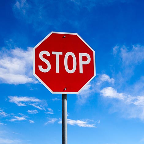 Conceptual stop sign with blue sky background and copy space.