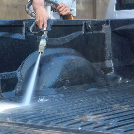 Pickup truck bed being washed