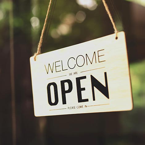 A business sign that says "u2018Open"u2019 on cafe or restaurant hang on door at entrance. Vintage color tone style. open sign of a small business