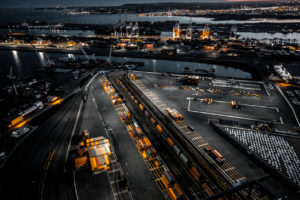 Aerial view of the New Jersey Shipyard with numerous cranes, gantries and shipping containers, captured at golden hour