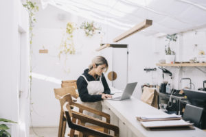 Candid portrait of cafe owner paying bills and ordering inventory