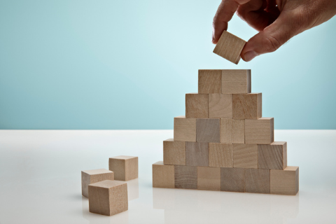 hand plays with wooden building blocks