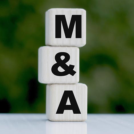 The concept of the word M&A on cubes on a beautiful green background wooden blocks with M & A