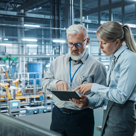 Project Manager Talks to Engineer, Plan Strategy Using Tablet Computer