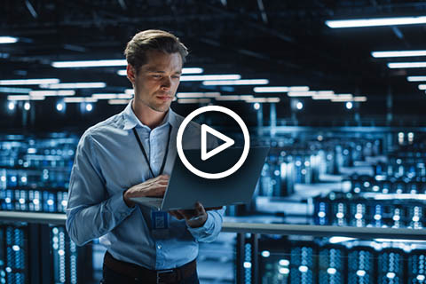 man with laptop in server room