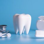 Fake tooth with dental equipment on a blue background