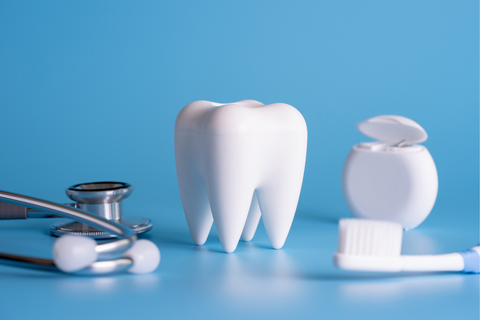 Fake tooth with dental equipment on a blue background