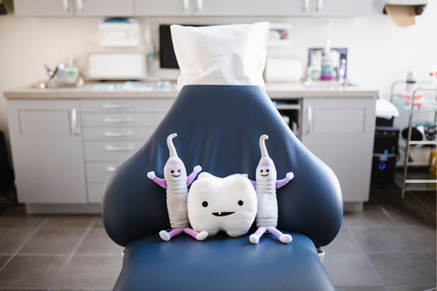 Dental office chair with dental themed stuffed toys