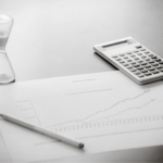 hour glass calculator and chart on a grey table