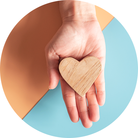 hand holding a wooden heart