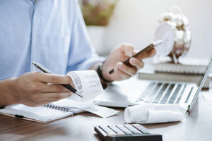 man reviewing expenses receipts