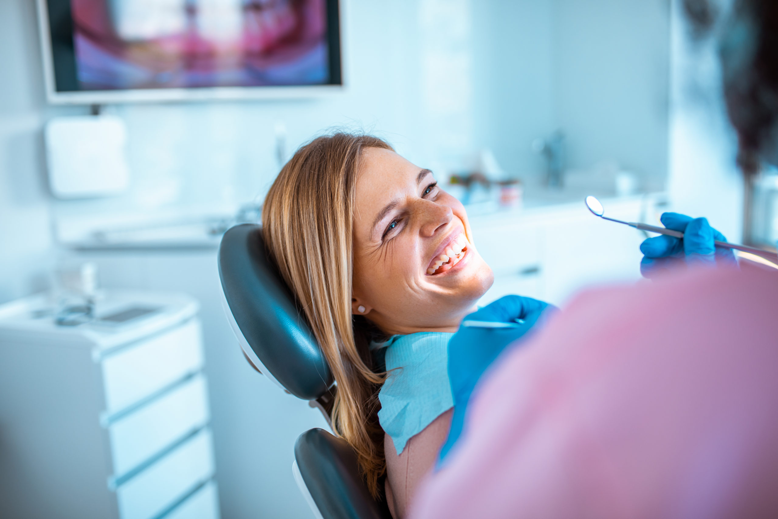 smiling woman sitting in dental chair