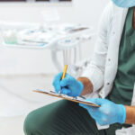 Dentist taking down notes