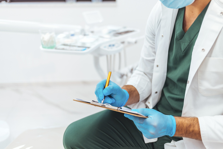 Dentist taking down notes