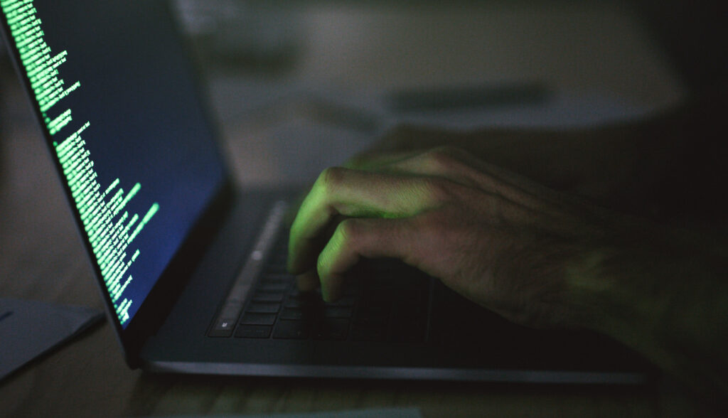 Close up of person typing on a laptop