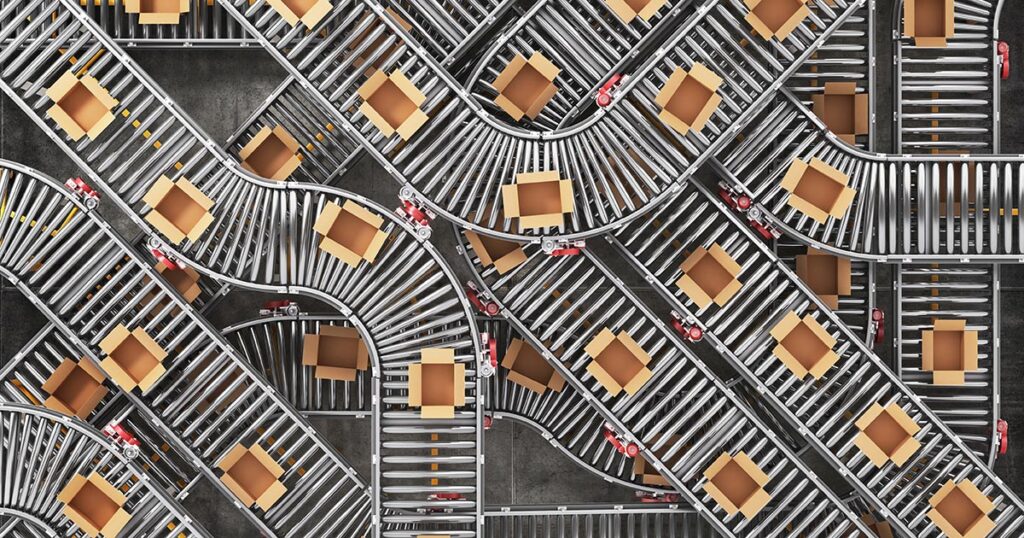 Looking down at a maze of conveyers and boxes