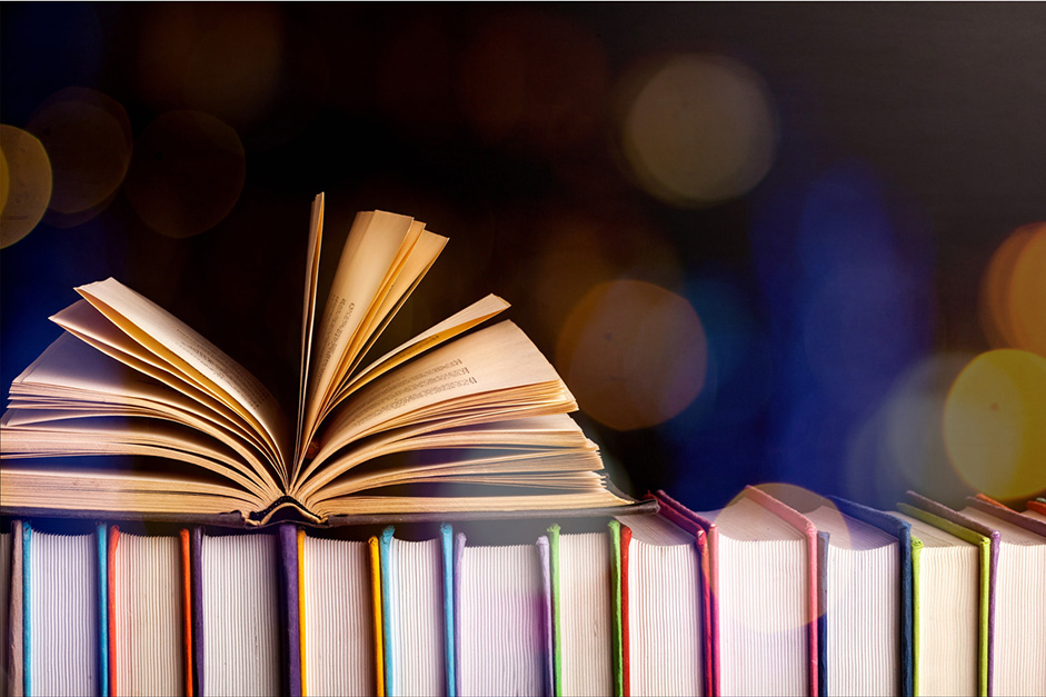Row of books with an open book on top