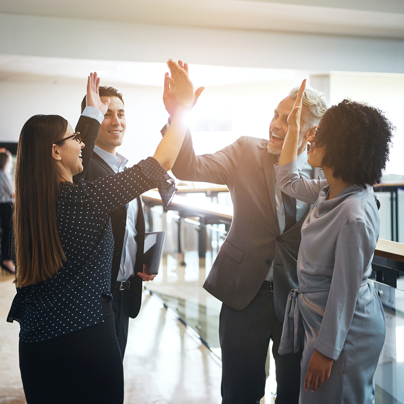 Group of business people giving out high fives