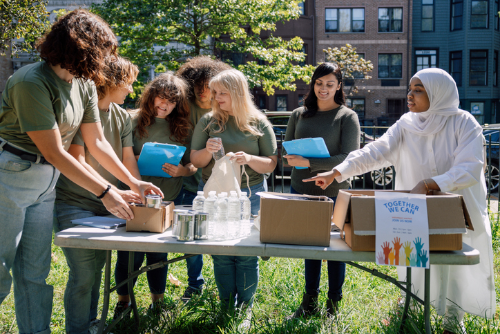 Charitable foundation giving their help in a New York City neighborhood, collecting food and clothes.