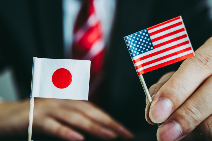 Businessman with Japanese and USA flags