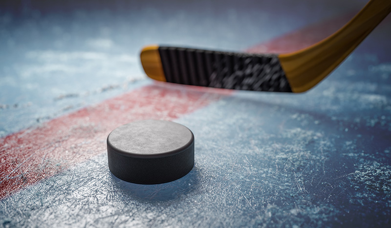 Hockey puck on ice at stadium. 3D rendered illustration. Hockey puck on ice at stadium. 3D rendered illustration.