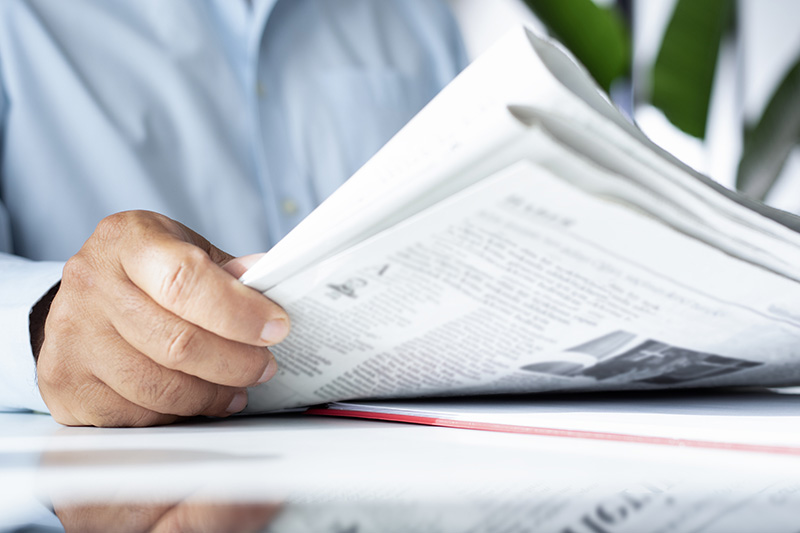 businessman reading newspaper at office businessman reading newspaper at office