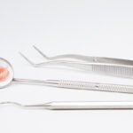Denture and mouth mirror, symbol photo for dentures