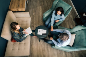 Three persons talking in the office