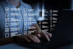 Businessman work at laptop doing online data checklist survey. Productivity checklist and filling survey form online. Fast checklist,clipboard task business management. - stock photo