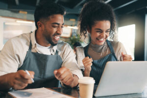 Laptop, team and success with people in cafe for product inventory, supplier deal and budget profit. Menu discounts, reputation rating and small business owner with employee in coffee shop for winner - stock photo