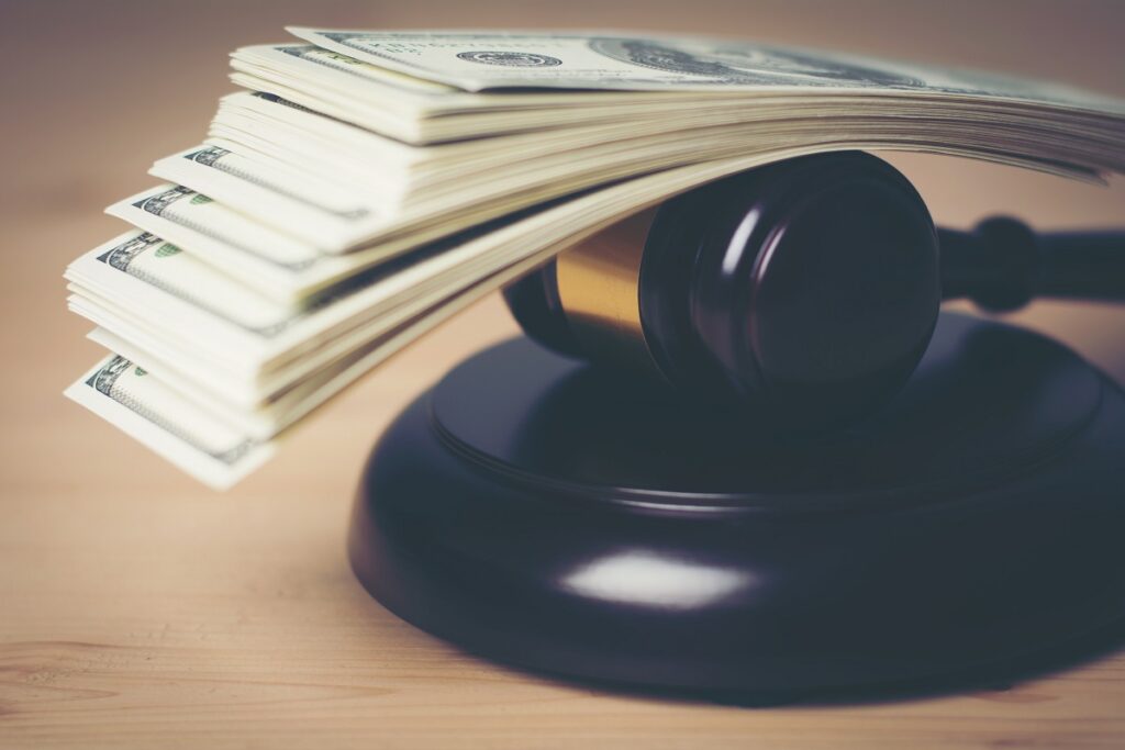 Concept of Legal court gavel on assorted cash, Close up.