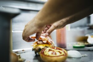 Chef preparing a cheeseburger
