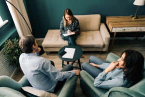 Three persons talking in the office