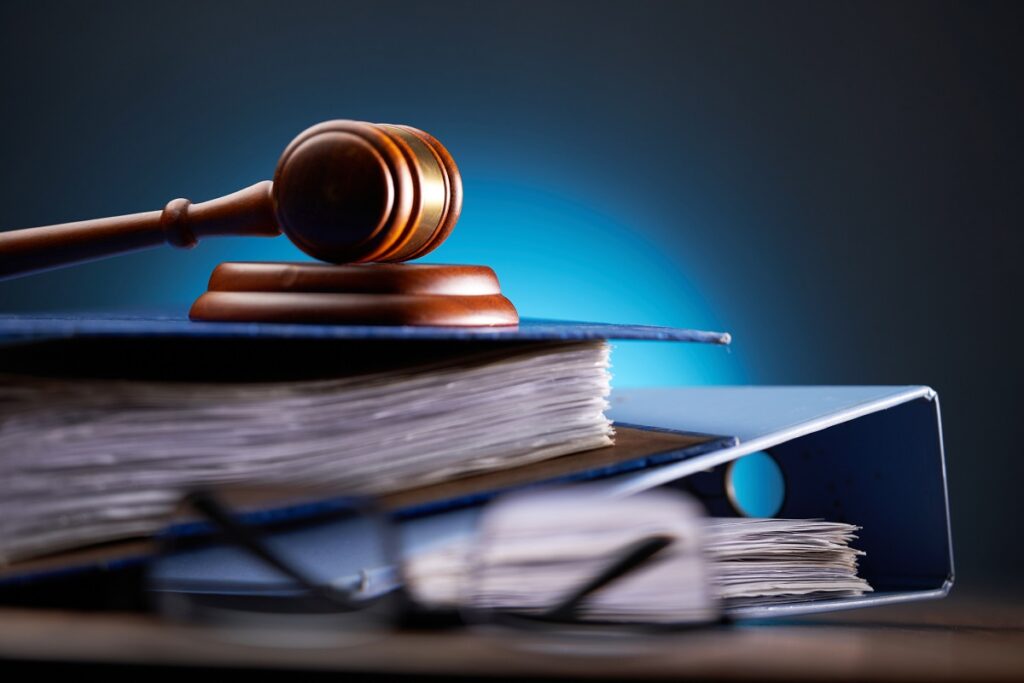 Close-up of gavel on books against black background