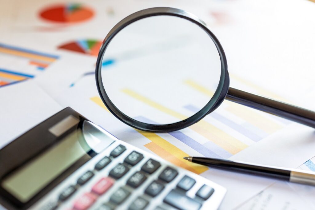 Analysis data information with magnifying glass and calculator