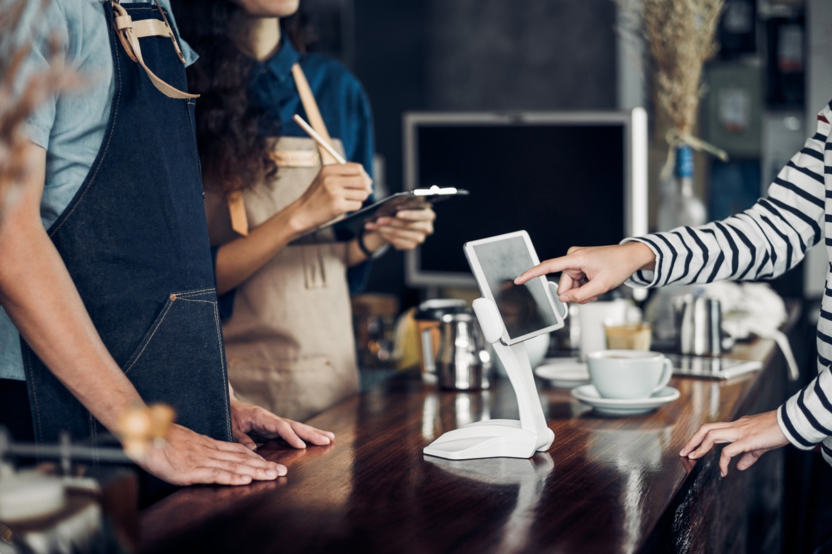customer self service order drink menu with tablet screen at cafe counter bar
