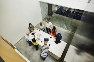 Wide high angle shot businesswoman leading project meeting in office