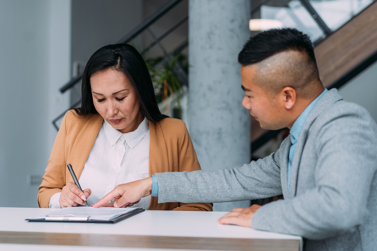 Business people signing a contract in the office.